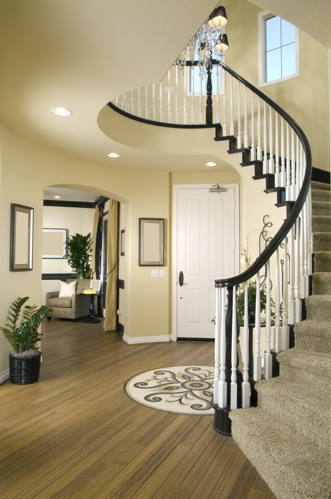 Modern entry way with wood floor and winding stairs Interior Design Ideas
