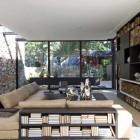 Elegant Living Area with View of Yard and Stone Wall