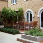 Gorgeous Courtyard Patio Furniture Bamboo Garden and Brick Wall