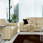Modern Western Living Room with Beige Leather Sofa and Brown Rugs