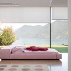 Cozy Pink Bedroom with Glass Wall and Lake View