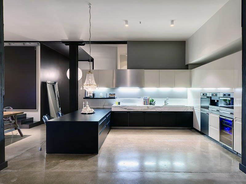 Black Kitchen Countertop With Polished Concrete Floors Interior
