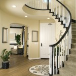 Modern entry way with wood floor and winding stairs