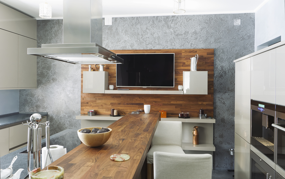 Modern kitchen with wood countertops and TV