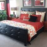Modern master bedroom with red sheets black bed frame