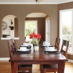Nice place setting on wood dining room table with vase
