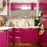 Pink kitchen cabinets with wood floor