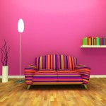 Pink wall room with multi color couch