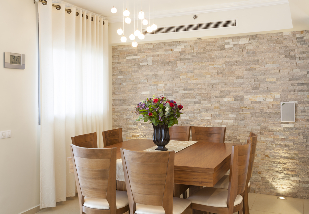 Wood dining room table with stone wall